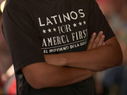 A man wearing a "Latinos for America" t-shirt attends a campaign event for Repub