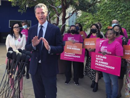 FILE— California Gov. Gavin Newsom talks at a news conference with workers and volunteer
