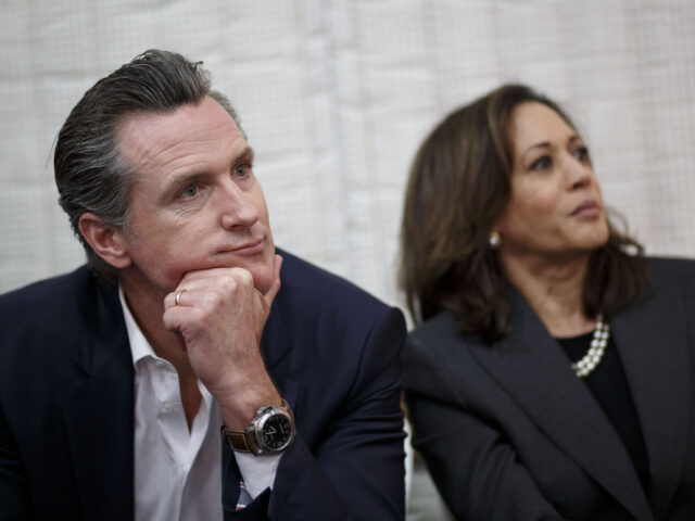 Gavin Newsom, Democratic candidate for governor of California, left, listens while seated