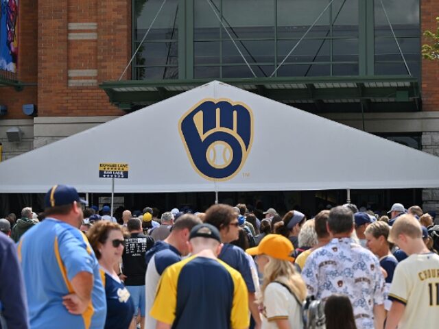 Patrick Gorski_Icon Sportswire via Getty Images MILWAUKEE, WI - AUGUST 28: Fans line up outside to prior to entering an MLB game between t