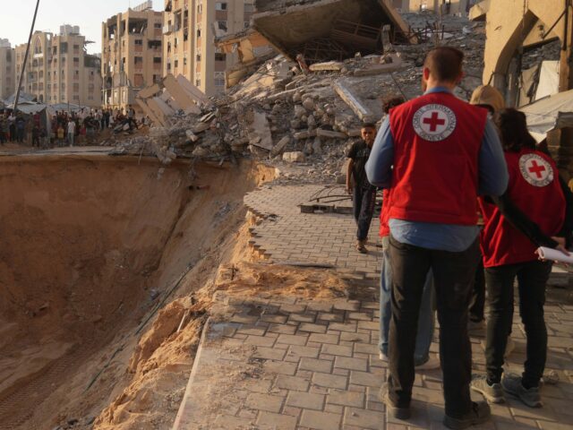 Red Cross Gaza (Abdel Kareem Hana / Associated Press) Red Cross workers check the site where members of the Hamas militant group work on searchi