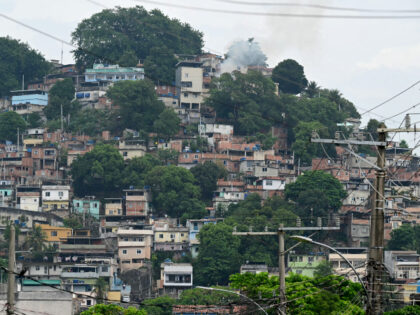 Smoke rises from a house in the Vila Cruzeiro favela at the Penha complex in Rio de Janeir