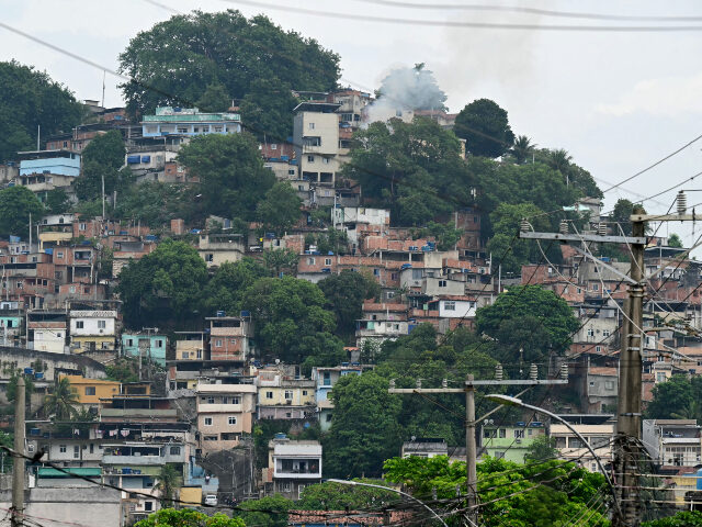 Smoke rises from a house in the Vila Cruzeiro favela at the Penha complex in Rio de Janeir