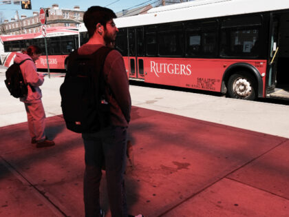 Rutgers students wait for a bus on the morning that faculty and students began a strike at
