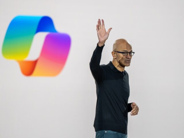 Satya Nadella of Microsoft with Copilot logo