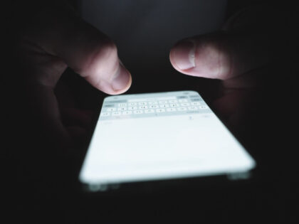 Hands of man chatting on the mobile phone, typing message. Slow motion - stock photo, Nata