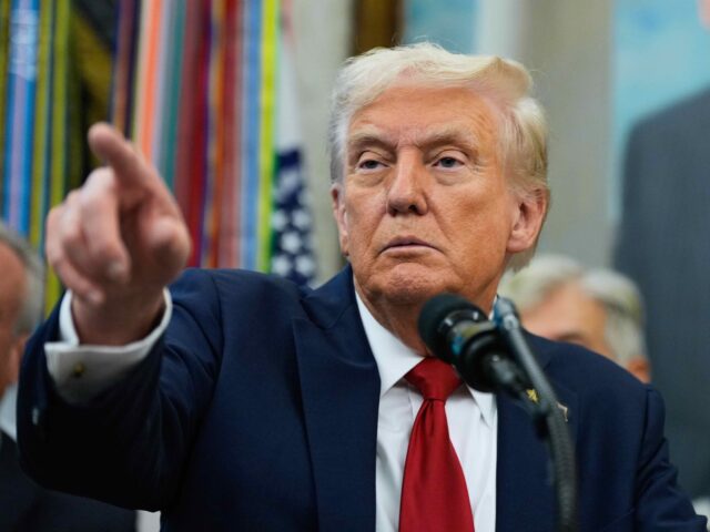 President Donald Trump points to a reporter in the Oval Office of the White House, Tuesday