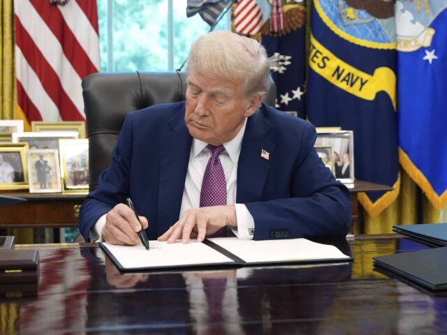 Trump signs Oval Office (Associated Press)