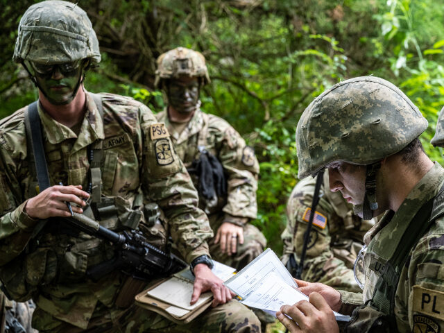 Cadets of the 3rd Regiment plan their approach to the objective in Training Area 9 during