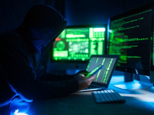 a hacker at work extorting companies