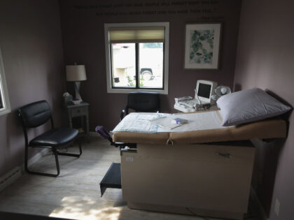 An ultrasound machine sits next to an exam table in an examination room at Whole Woman