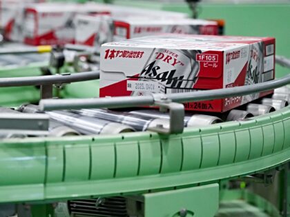 Boxes containing cans of Asahi Super Dry beer move on the production line inside the Asahi