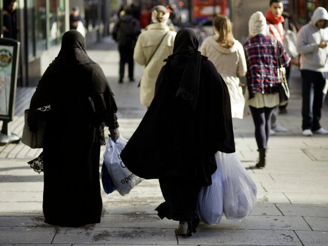 burqa-wearing women in England Europe, UK, England, London, View Of Two Muslim Women Wearing Burka's Cruising Edgwar