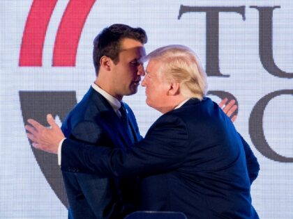 President Donald Trump shakes hands with Turning Point USA Founder Charlie Kirk as he fini