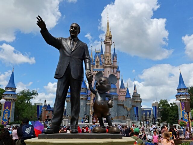 disney ORLANDO, FL - APRIL 3: A statue of Walt Disney and Mickey Mouse stands in a garden in fron