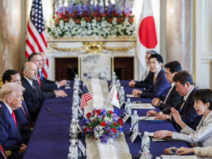 Japan's Prime Minister Sanae Takaichi (R) speaks during the Japan-US summit meeting with U