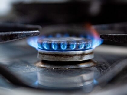 BARCELONA, SPAIN - 2022/10/08: A gas stove lets off a blue flame inside a household kitche
