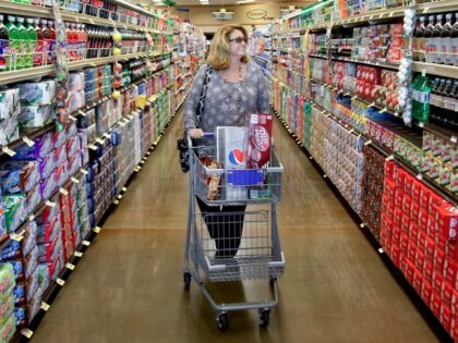 UNITED STATES - JUNE 23: Pam Reece walks down the soft drink isle as she shops at a Kroger