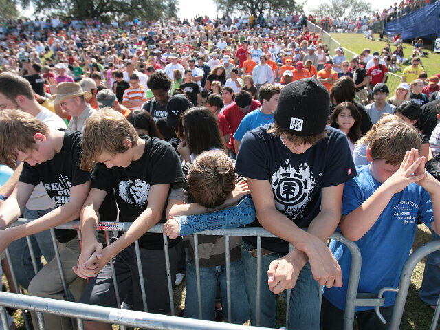 group of young people praying (left to right) Rick Holthoff, 18, brother Alex Holthoff, 15, Josh Blair, Joseph Clawson,