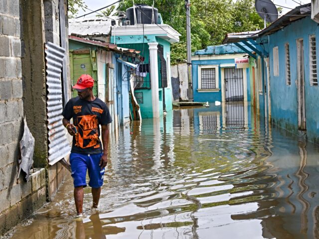 hurricane melissa cleans up A couple leaves their flooded house after the passing of the tropical storm Melissa before