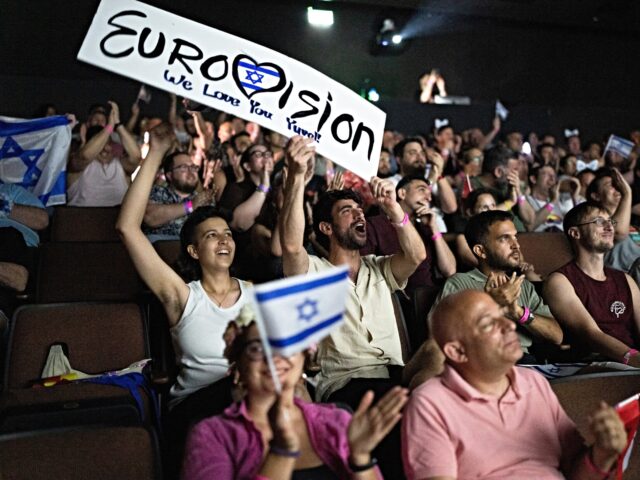 israel eurovision People cheer as they watch the 2025 Eurovision Song Contest finals being screened at a com