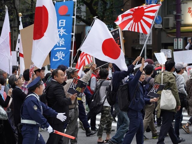 japan-immigration-protest-getty Demonstrators hold flags and placards as they march during a rally against Japan Prime Min