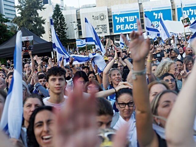 Israelis react as they watch the release of Israeli hostages by Hamas during a live broadc