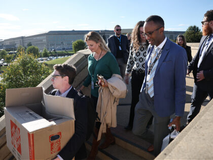 ARLINGTON, VIRGINIA - OCTOBER 15: Pentagon reporters walk out of the building carrying the