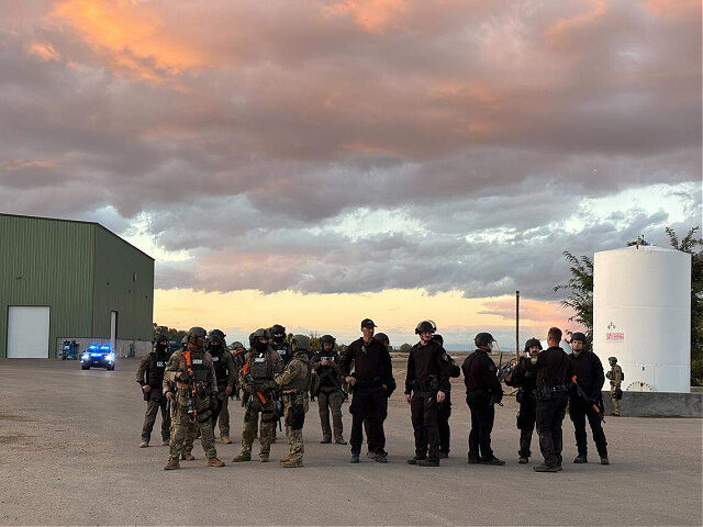 Agents stand at La Catedral Arena in Wilder on Sunday. Multiple law enforcement agencies,