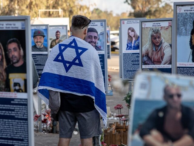 october-7-memorial-getty RE'IM, ISRAEL - OCTOBER 07: A man looks at memorials of the lost and kidnapped at the