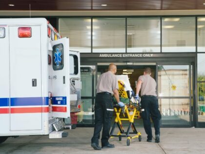 patient wheeled from ambulance to ER