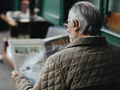 Man Sitting Reading Newspaper