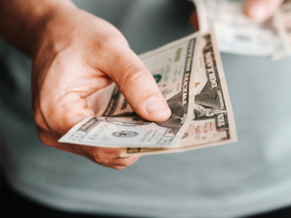 man paying with American dollars