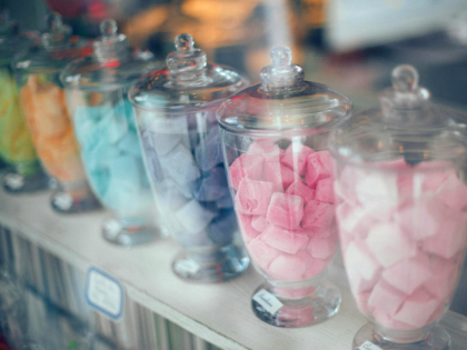 Assortment of various multicolored sweets on counter in store