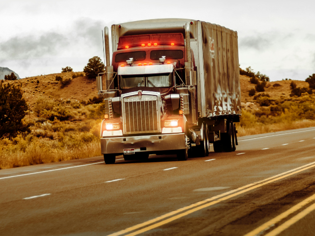 Red and Silver Truck on Asphalt Road
