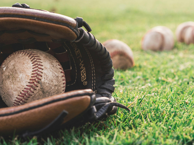 White Baseball On Brown Leather Mitt