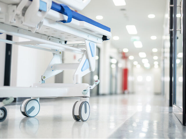 stock-stretcher-gurney-hospital-bed-down-hallway-getty Close-up of A stretcher gurney bed stands ready in the hospital corridor, awaiting the nex