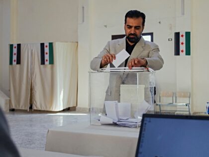 A man casts his vote at a polling station in Ariha, Idlib Governorate, Syria, on October 5