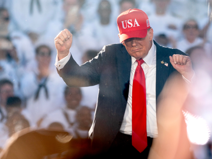President Donald Trump dances to the song “YMCA” during a celebration for the U.S. Nav