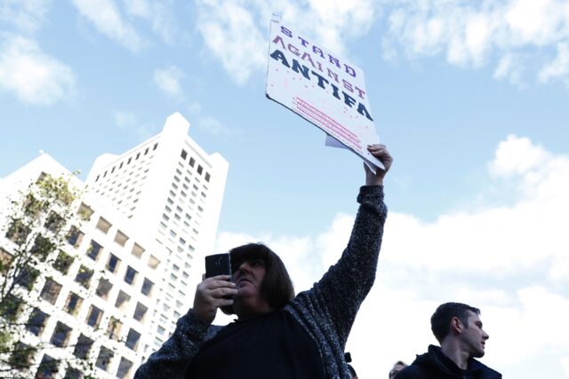 A conservative activist holds a sign against Antifa in November 2017 in San Francisco, Cal