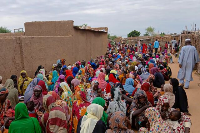 A file picture from August of people gathering to receive food in Sudan's El-Fasher,