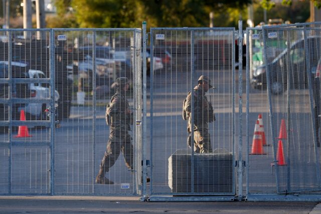 National Guard troops are seen near an entrance to a US Immigration and Customs Enforcemen