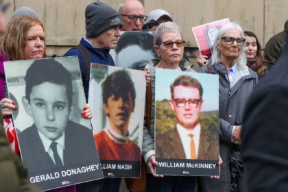 Relatives gathered outside the Belfast court at the start of the trial last month bearing