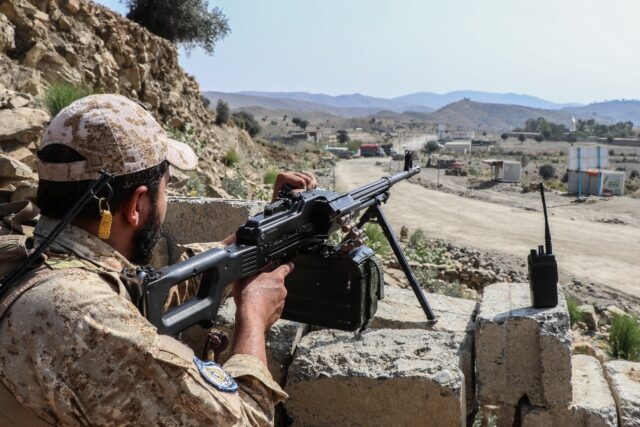 A Taliban security personnel stands guard along a road near the Ghulam Khan zero-point bor