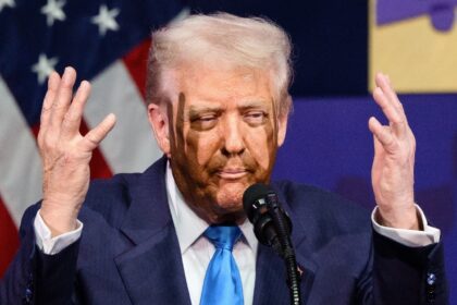 US President Donald Trump gestures as he speaks during the Asia-Pacific Economic Cooperati