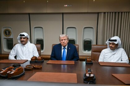 US President Donald Trump meets Qatar's Emir Sheikh Tamim bin Hamad Al-Thani (L) and