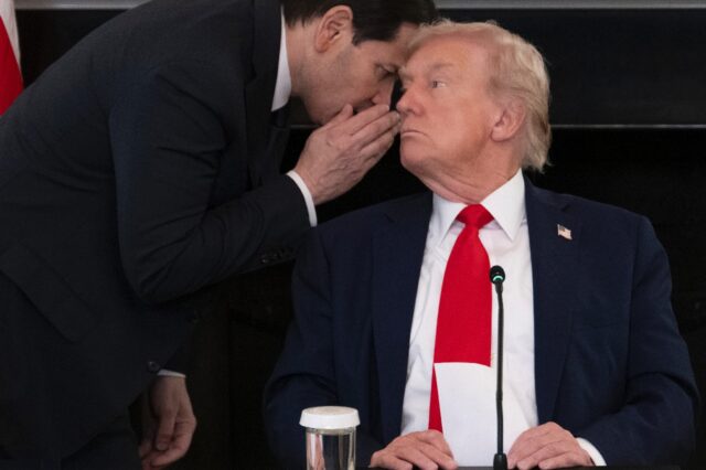 US Secretary of State Marco Rubio whispers to President Donald Trump at the White House af