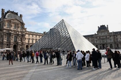 Visitors queue to get in to the Louvre, days after it was robbed in Paris