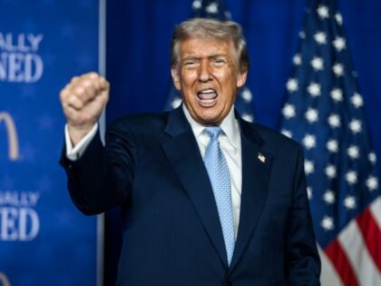 President Donald Trump gestures to the crowd after delivering remarks at the McDonald’s
