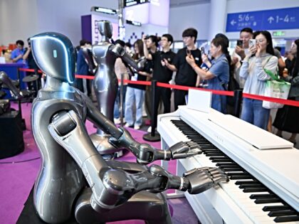 HANGZHOU, CHINA - SEPTEMBER 26: A robot plays the piano during the 4th Global Digital Trad